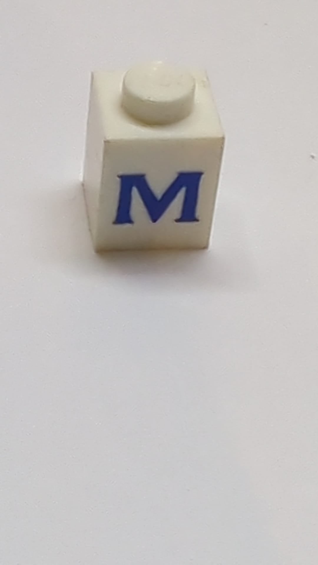 1x1 Stein mit blauem Großbuchstaben M Muster Serif Schriftart weiß