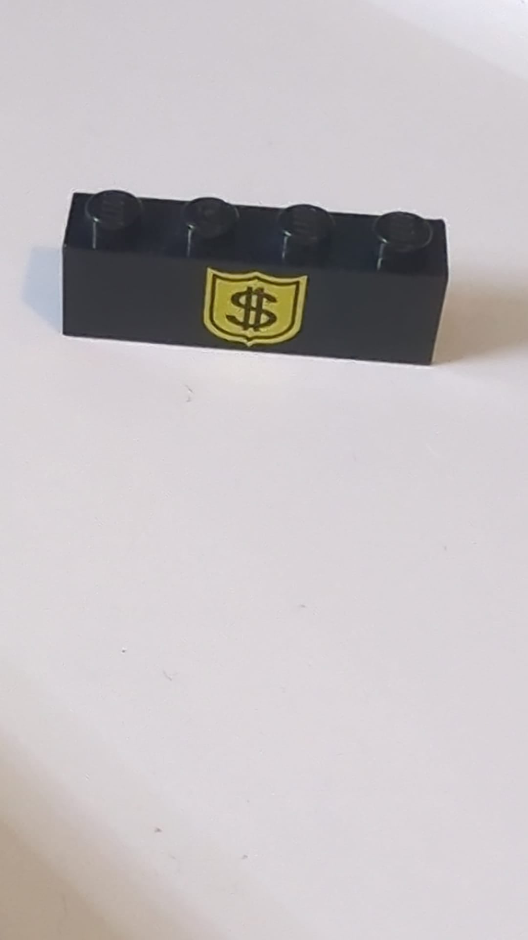 1x4 Stein mit Muster: schwarzes Dollarzeichen auf gelbem Abzeichen schwarz