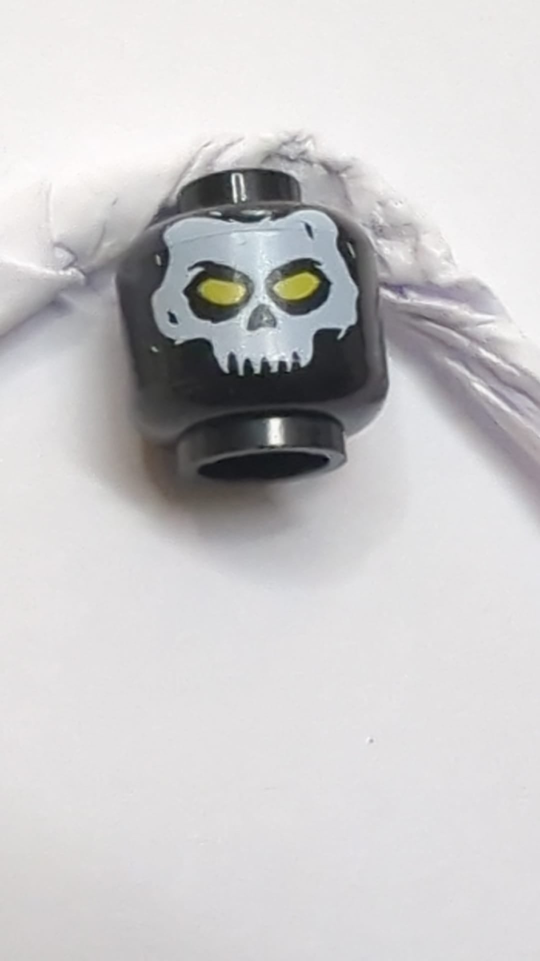 Minifigur, Kopf: Weiße Totenkopfmaske mit gelbem Augenmuster schwarz
