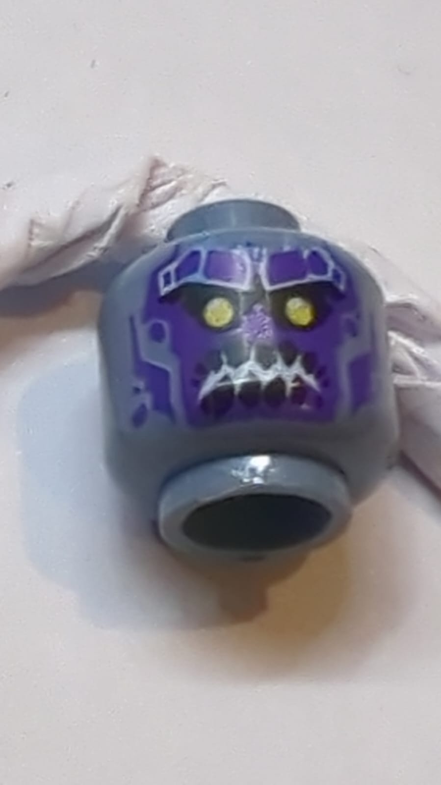 Kopf Zweiseitiger Außerirdischer mit gelben Augen, dunkelvioletten Felszähnen, Lächeln / wütendem Ausdruck