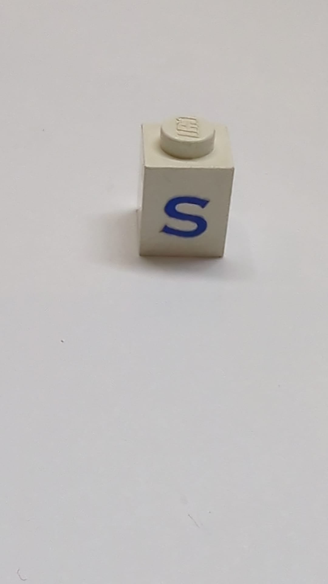 1x1 Stein mit blauem Großbuchstaben-S-Muster weiß