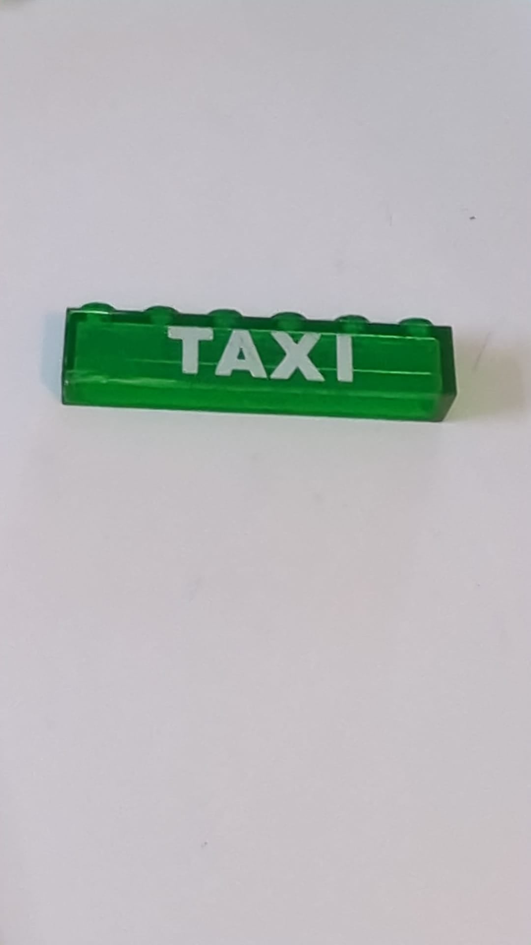 1x6 Stein ohne Bodenrohre mit weißem „TAXI“-Muster transparent grün