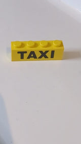 1x4 Stein mit schwarzem „TAXI“-Aufdruck gelb