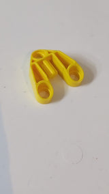 3x3 Technic, Stiftverbinder mit Achse und 3 Stiftlöchern gelb