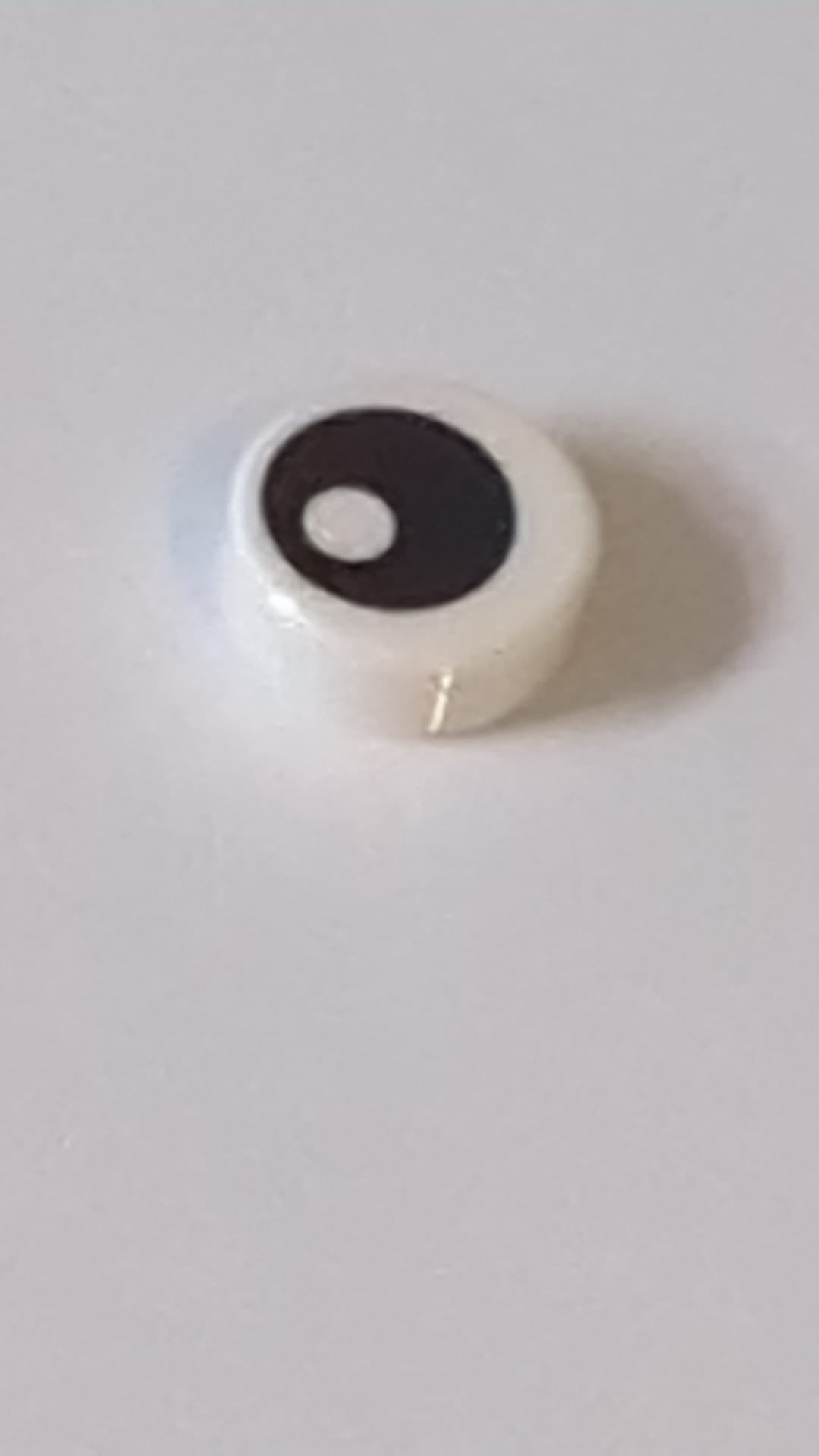 1x1 Fliese, rund mit Muster: schwarzes Auge mit Pupille weiß