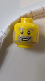 Minifigur, hellblaugrauer Kopf, buschige Augenbrauen und Bart, offener Mund mit Lächeln und sichtbarem Zahnmuster gelb