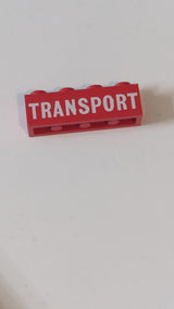 1x4 Stein mit weißem, vollflächigem „TRANSPORT“-Aufdruck rot