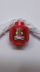 Kopf eines Außerirdischen mit gelben Augen, dunkelroten Falten, freiliegendem Zahnmuster rot