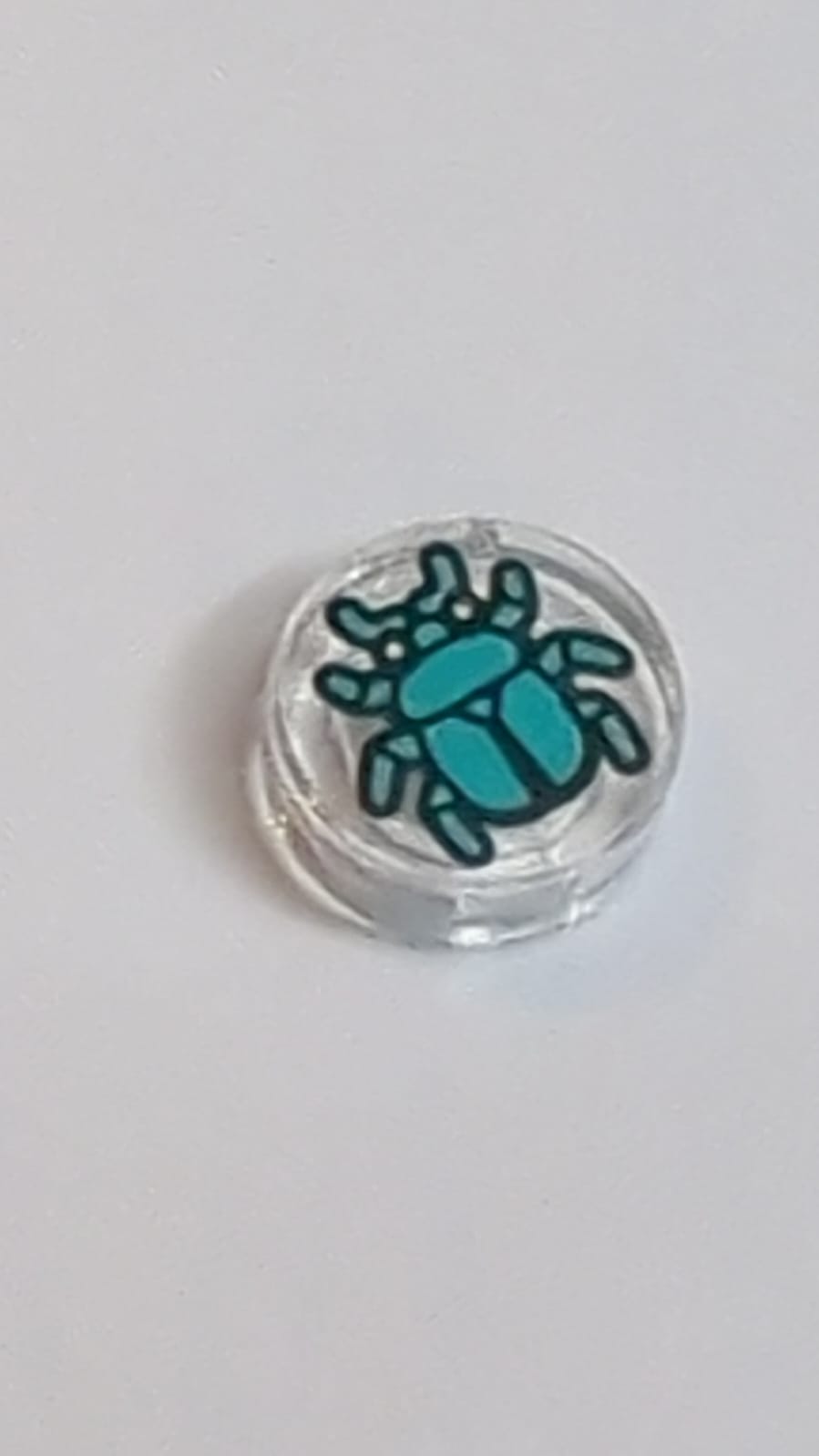 NEU Fliese, rund 1 x 1 mit dunkel-türkisfarbenem Käfermuster transparent weiß