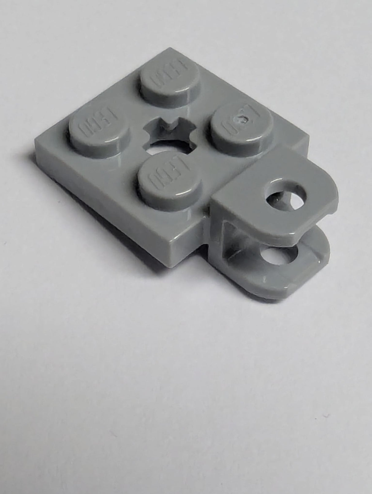 NEU Plate, Modified 2 x 2 with Tow Ball Socket, Short, Flattened with Holes and Axle Hole in Center neuhellgrau light bluish gray