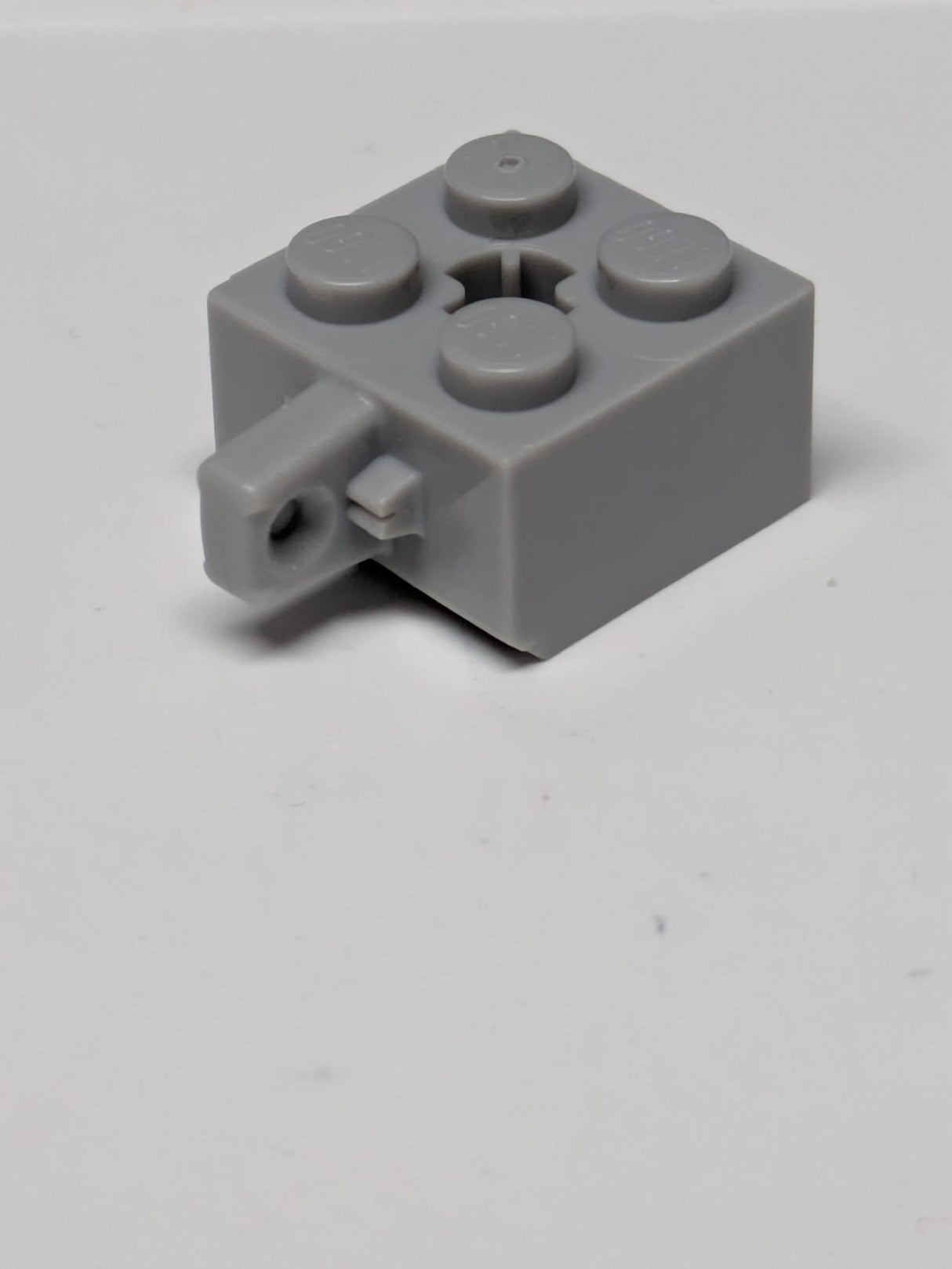 2x2 Scharnierstein verriegelnd mit 1 Finger, vertikal und Achsloch (+ Form) neuhellgrau