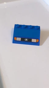 3x4 Schrägstein Fahrzeug, Kotflügel mit silbernen Scheinwerfern, orangefarbenen Blinkern und schwarzem Kühlergrill mit Logo-Muster (weißes Dreieck im Oval) blau